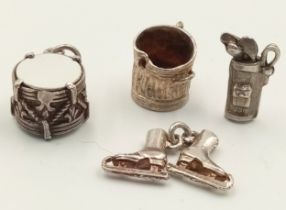 A SELECTION OF 4 X STERLING SILVER CHARMS - DUSTBIN, ICE SKATES, GOLF BAG WITH CLUBS, AND DRUM. 9g