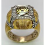 An 18K Yellow Gold Diamond Dress Ring. A 2.5ct central globular cut yellow diamond, with a round cut