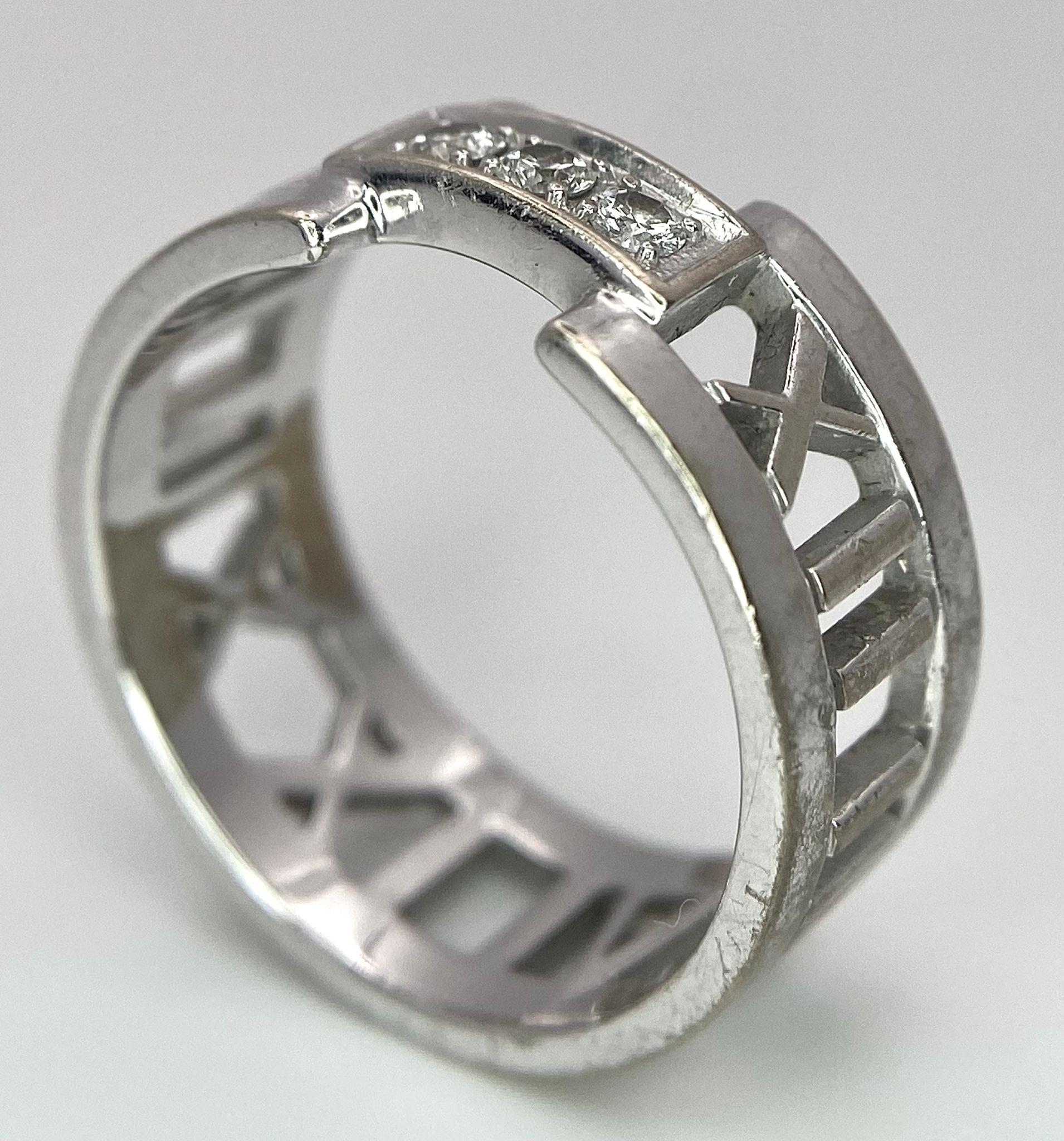 An 18K White Gold Tiffany Atlas Diamond Ring. Pierced Roman numeral decoration. Tiffany mark. Size - Image 7 of 9