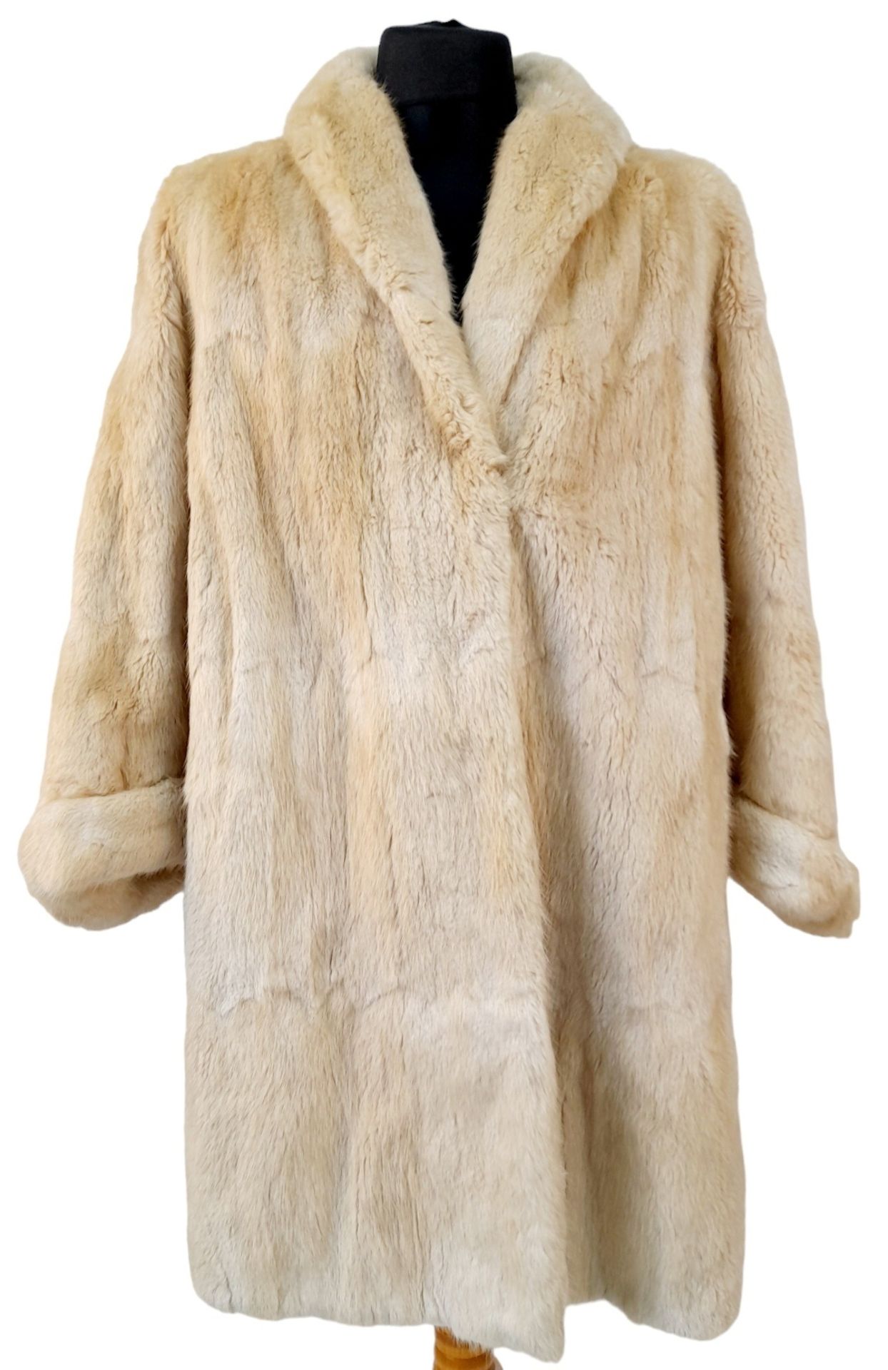A Barkers of Kensington Three-Quarter Length White Fur Coat.