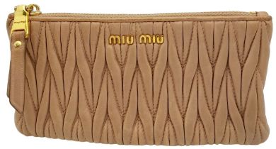 A Miu Miu Dust Pink Purse. Matelassé leather exterior with gold-toned hardware and zipped top
