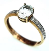 A 9K YELLOW GOLD DIAMOND & AQUAMARINE SET RING. OVAL AQUAMARINE GEMSTONE APPROX 0.75CT. 1.8G. SIZE N