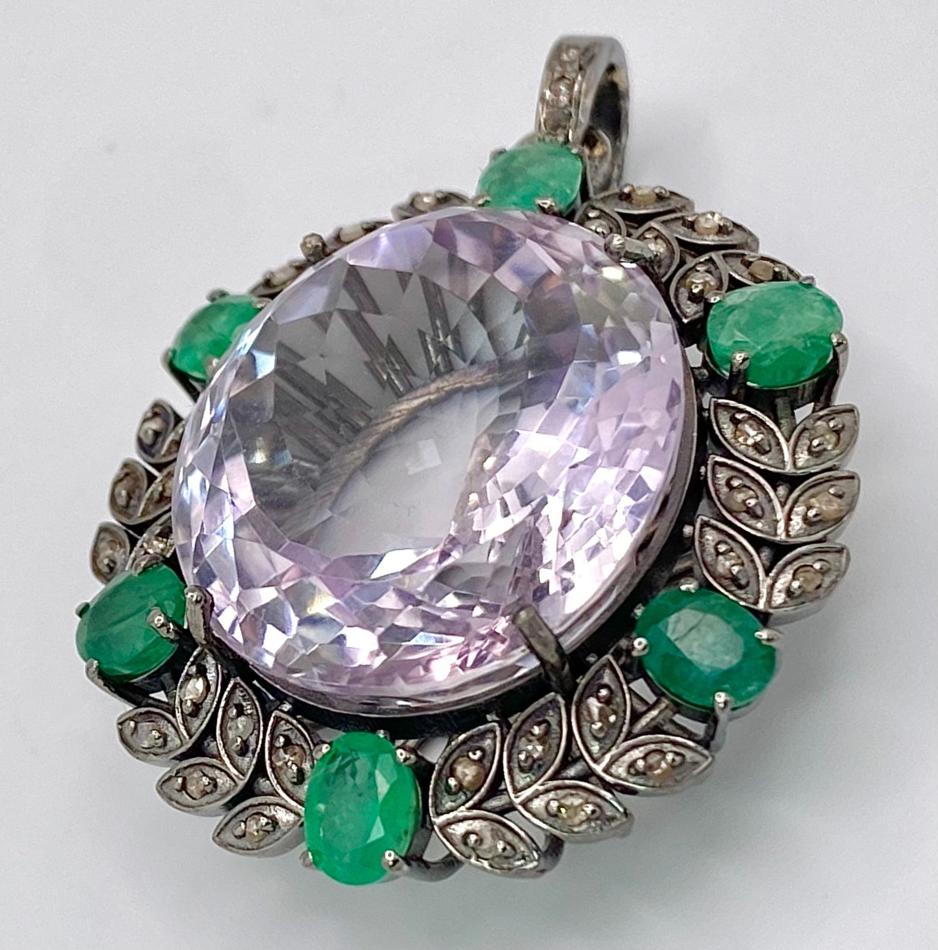 A 30.4ct Amethyst, Emeralds and Diamond Pendant set in 925 Silver. A beautiful clean amethyst with a
