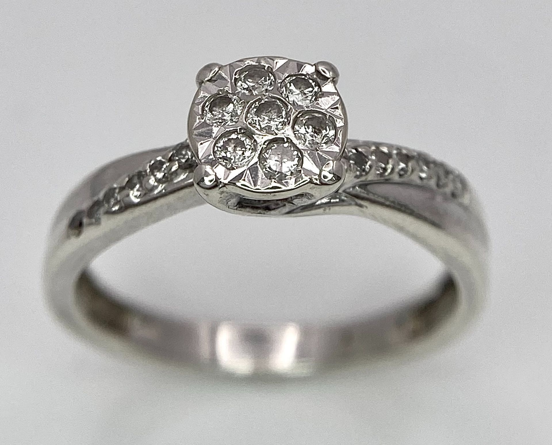 A 9K White Gold Diamond Cluster Ring. Seven small diamonds on a circular base with diamonds on - Image 3 of 6