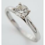 An 18K White Gold Diamond Solitaire Ring. 0.50ct brilliant round cut, slightly tinted. Size N. 2.