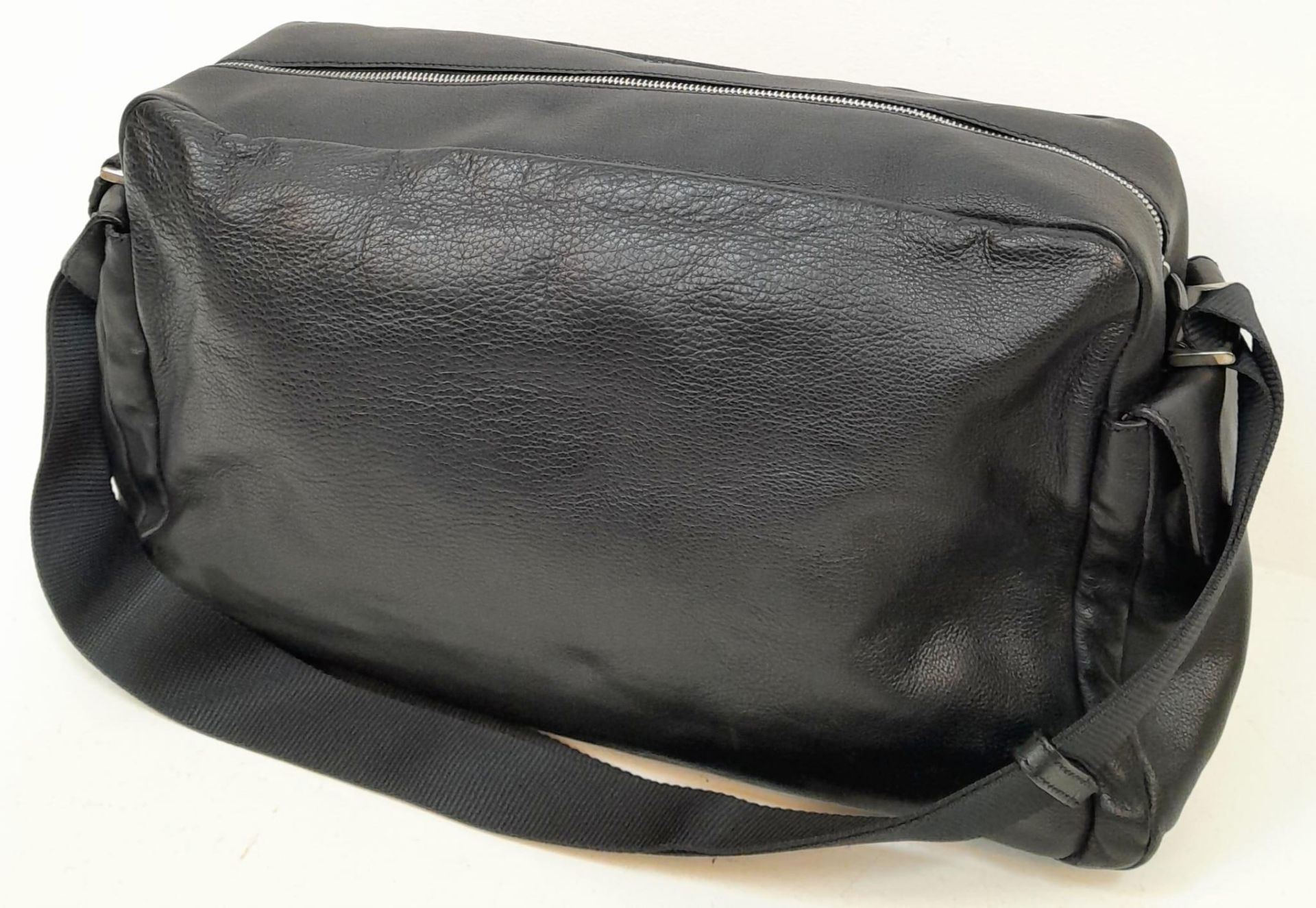 A Prada Black Duffle Bag. Leather exterior with silver-toned hardware, zipped outer compartment to - Image 3 of 12