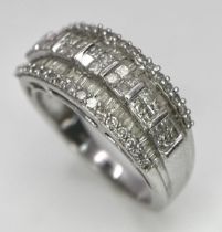 A 9K White Gold Mixed Cut Diamond Ring. Five rows of, square, round and baguette cut diamonds.