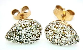 A PAIR OF 9K YELLOW GOLD PEAR SHAPED DIAMOND SET STUD EARRINGS. 9mm length, 1.2g total weight.