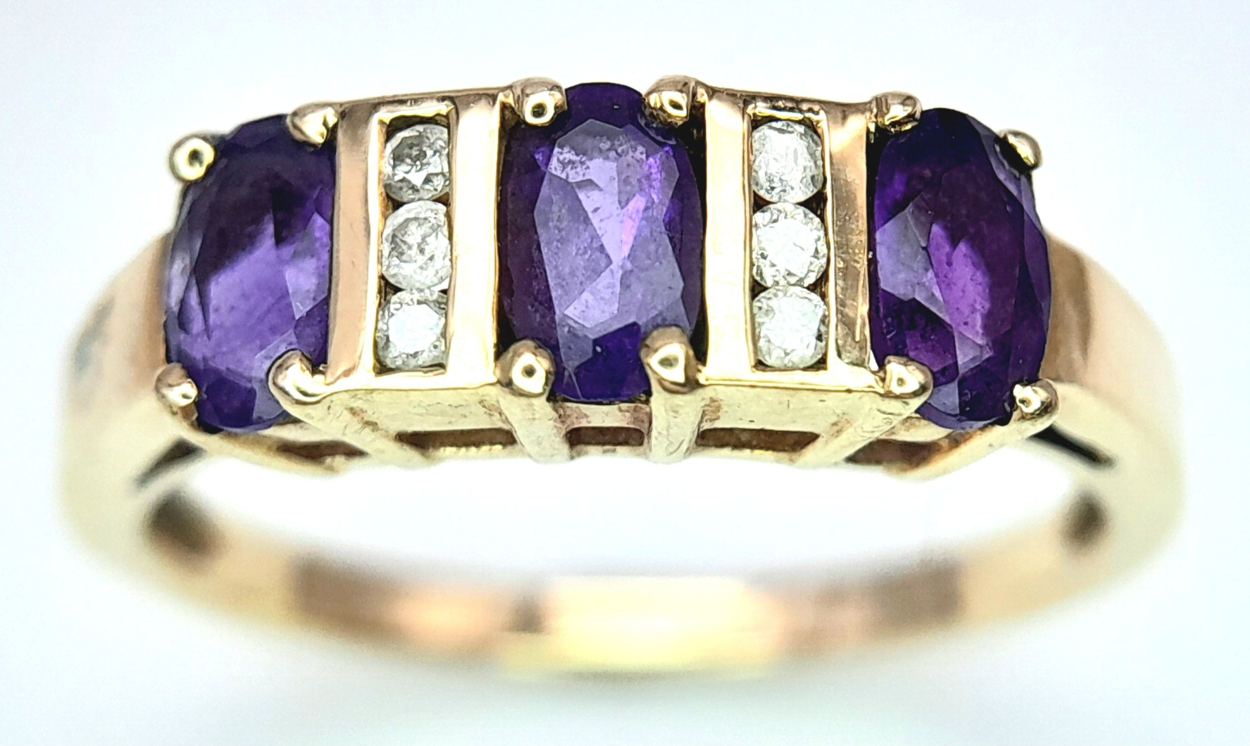 A 9K Yellow Gold Diamond and Amethyst Ring. Size M. 1.9g total weight.