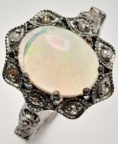 An Ethiopian Opal Ring with Rose Cut diamond Surround and Accents. Set in 925 Sterling silver.