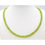 A Peridot Gemstone Tennis Bracelet with a Peridot Rondelle Necklace. Both with silver clasps.
