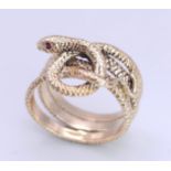 A 9K Yellow Gold Serpent Ring. A three band coiled body, ready to strike with ruby eyes. Size M 1/2.