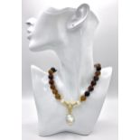 A Brown Stripe Agate Beaded Necklace with Hanging Baroque Keisha Pearl Pendant. 12mm beads. Gilded