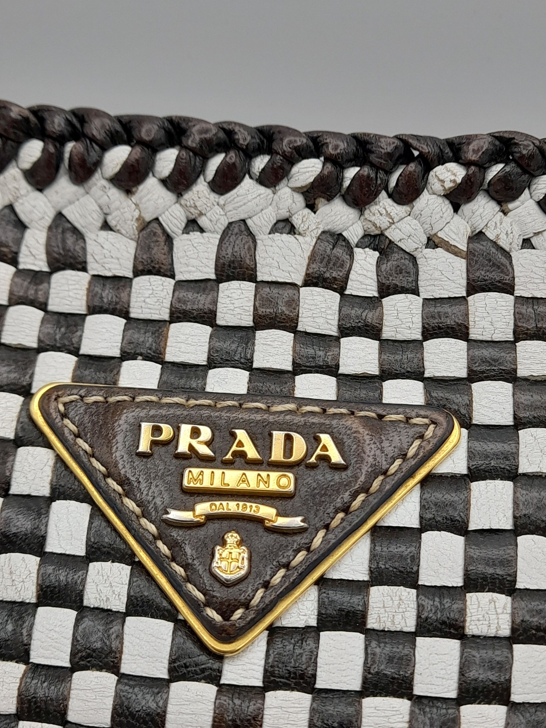 A Prada Black and White 'Madras' Clutch Bag. Woven leather exterior with gold-toned hardware and - Image 5 of 9