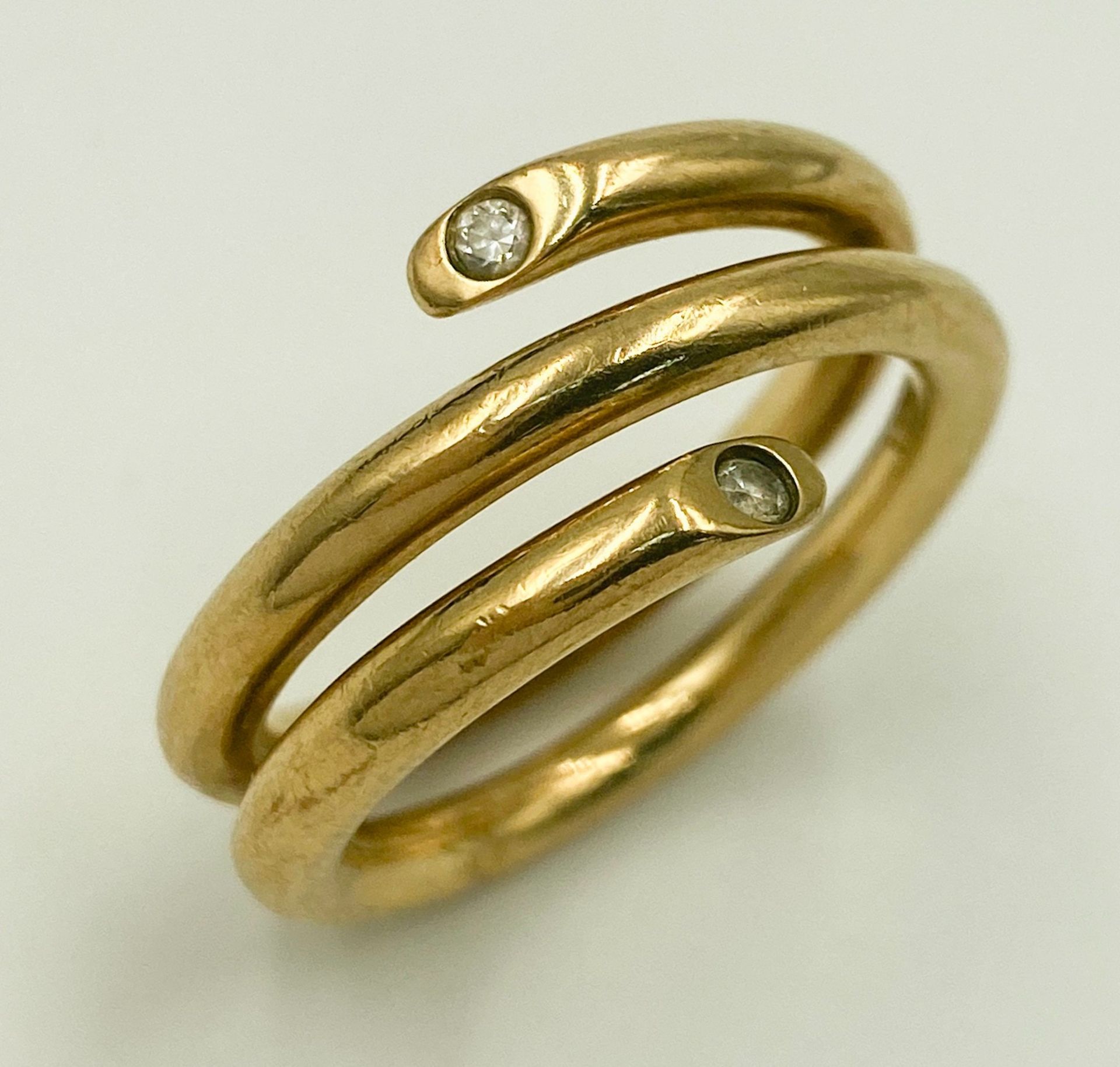 A 9K YELLOW GOLD, SERPENT STYLE DIAMOND BAND RING. 10G. SIZE T.