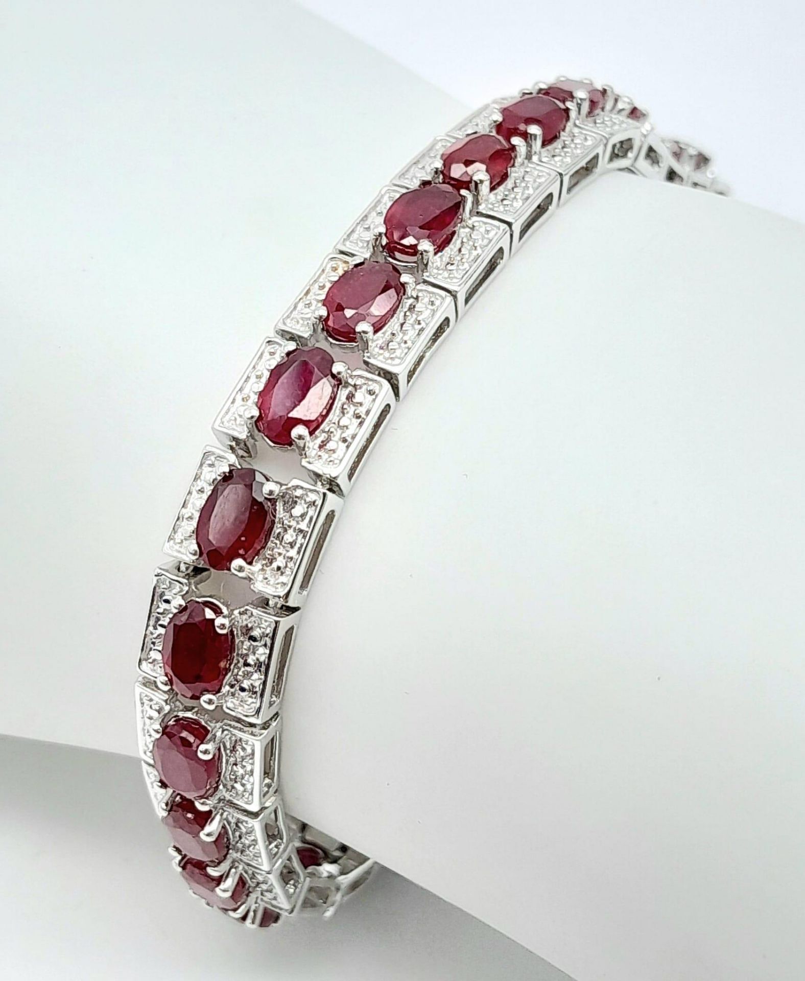 An Exquisite Hallmarked 2018 Sterling Silver 28 Oval Cut Ruby Set Bracelet. Each Ruby Measures 5mm