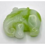 A Chinese Green and White Jade Elephant Figurine Pendant. 5cm x 4cm.
