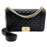 A Chanel Black Boy Bag. Quilted leather exterior with gold-toned hardware, chain and leather