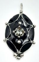An Antique Black Enamel and Silver Pendant. 3cm