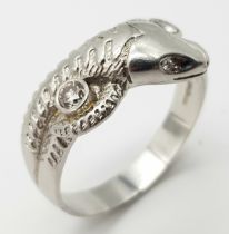 A Very Large 950 Platinum and Diamond Snake Ring. A coiling serpent with diamond eyes and body. Size
