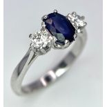 AN 18K WHITE GOLD, DIAMOND AND SAPPHIRE 3 STONE RING. OVAL BLUE SAPPHIRE - 0.75CT AND 0.30CT OF