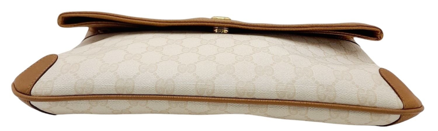 A Gucci Ivory GG Monogram Clutch Bag. Leather exterior with brown trim, gold and silver-toned GG, - Image 10 of 10