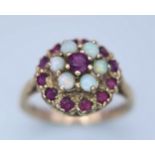 A 9K YELLOW GOLD GARNET AND OPAL CLUSTER RING. Size O, 3.8g total weight. Ref: SC 8088