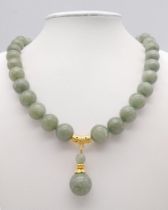 A Celadon Jade Bead Necklace with Drop Pendant. Rich 12mm jade beads. Gilded drop pendant - 4cm.