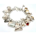 A vintage sterling silver multi-charm bracelet. Total weight 68G. Please see photos for details.