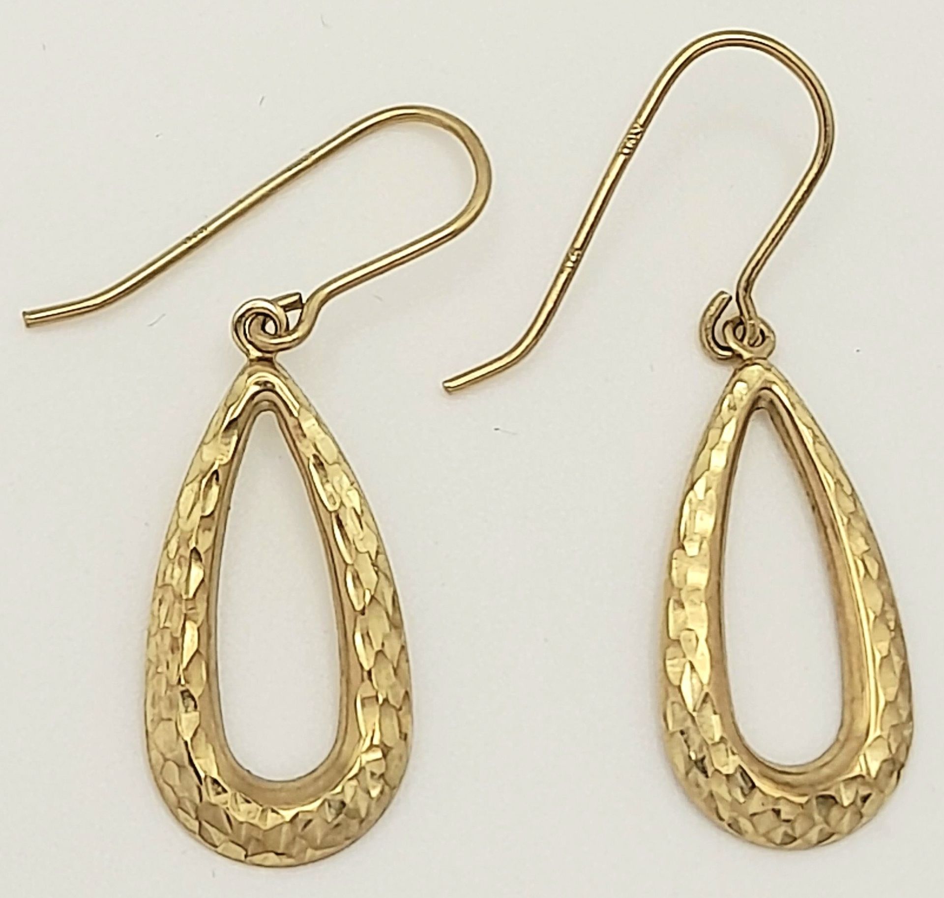 An attractive pair of 9 K yellow gold earrings, wonderfully catching the light from every direction,