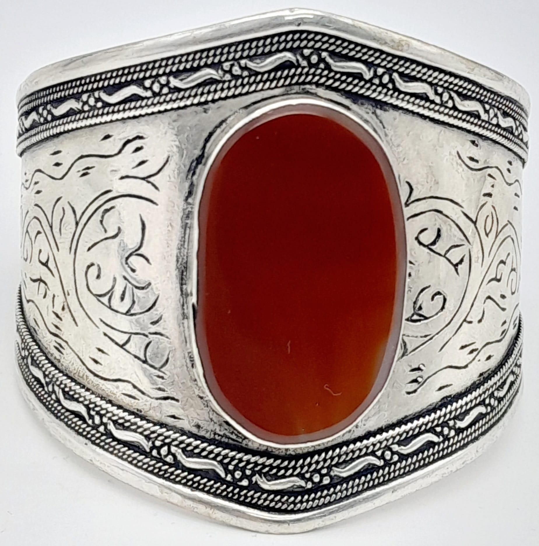 A Wonderful Trio of: Carnelian cuff bracelet, 800 German silver earrings and Berber amber resin - Image 2 of 6