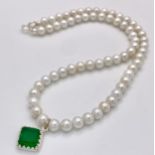 A Cultured Pearl Bead Necklace with Hanging Emerald Pendant - set in silver. 42cm.