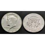 A 1964 Uncirculated Kennedy Silver Half Dollar.