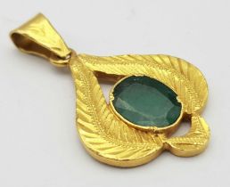A 22K Yellow Gold and Emerald Pendant. Decorative leaf pattern with a central oval emerald. 4cm. 4.