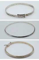 A collection of 3 silver bangles (A/F). One of them marked with 835 silver, the others are click-