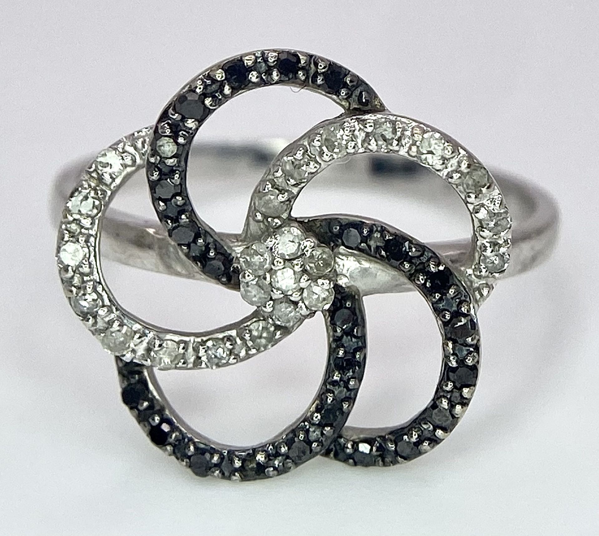 A 9K White Gold Black ad White Diamond Decorative Floral Ring. Size N. 2g total weight. - Image 3 of 7
