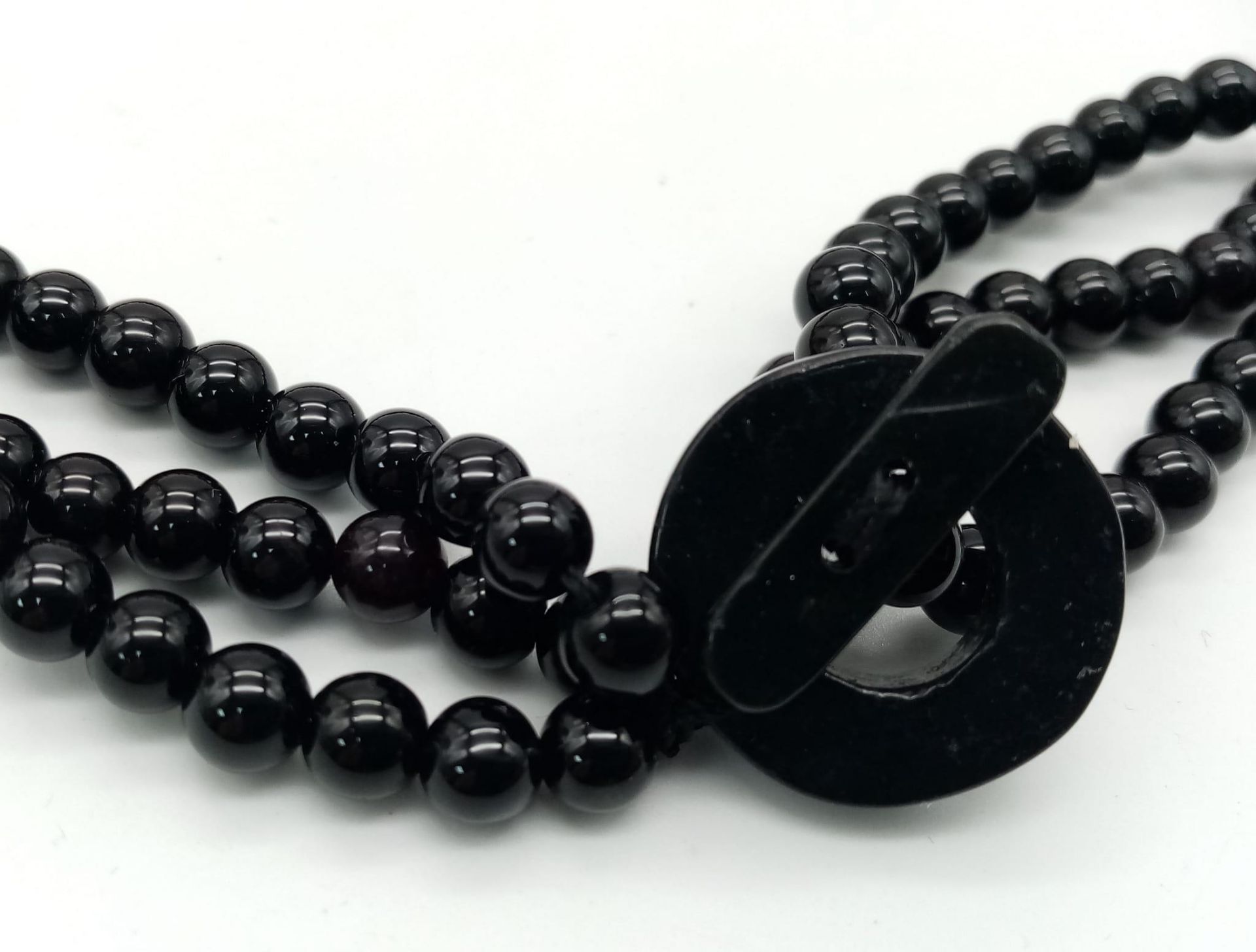 An exotic looking black onyx necklace adorned with large natural red coral pieces from South - Image 3 of 4
