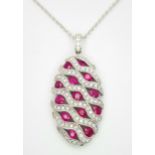AN 18K WHITE GOLD DIAMOND AND RUBY PENDANT - 0.49CT OF DIAMONDS AND 2.29CT OF RUBIES. 6.2G WEIGHT.