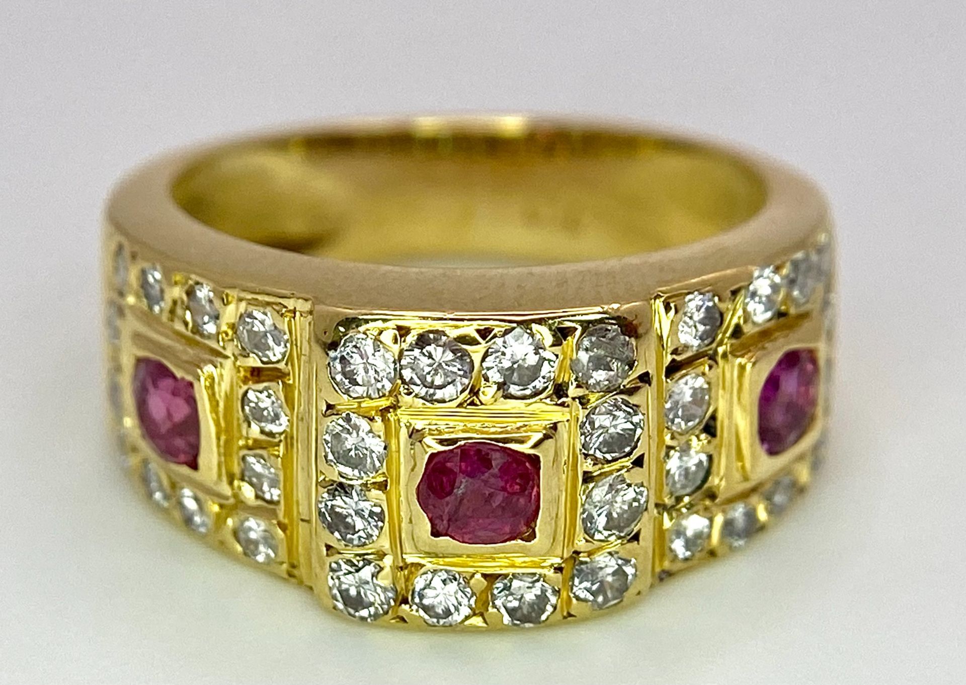 AN 18K YELLOW GOLD DIAMOND & RUBY RING. 0.60ctw, size K, 6.8g total weight. Ref: SC 8072