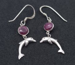 A Pair of Sterling Silver Ruby Set Dolphin Pendant Earrings. 2.5cm Drop. Set with 5mm Round Cut Ruby