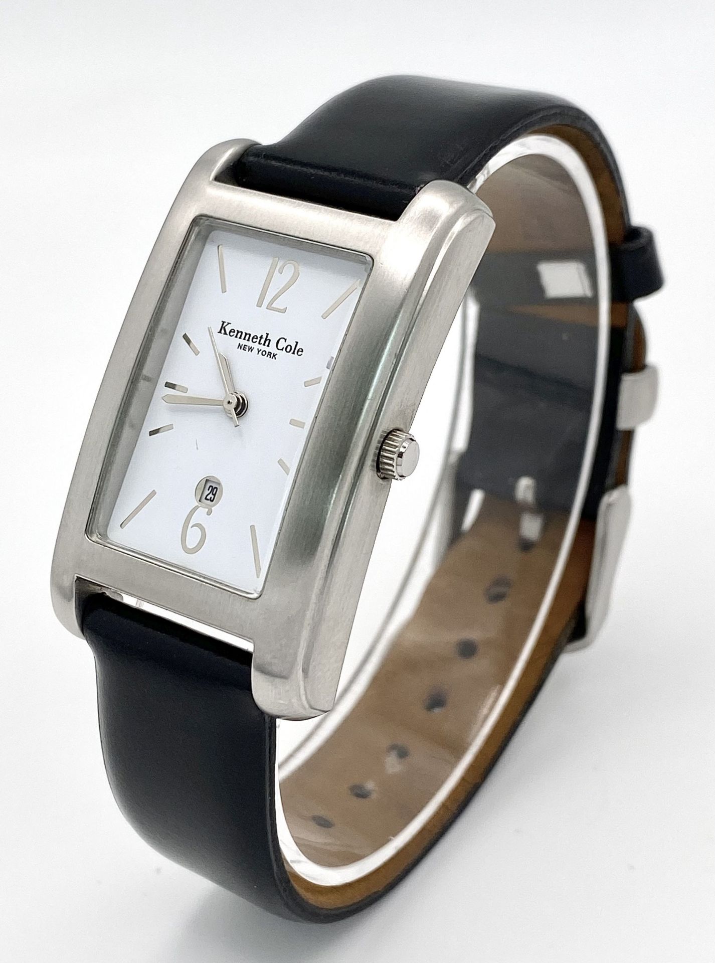 A Kenneth Cole New York Tank Style Quartz Date Watch. 26mm Case. Full Working Order. Comes with