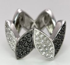 AN 18K WHITE GOLD BLACK & WHITE DIAMOND SET RING. 0.80ctw, size N, 11.8g total weight.