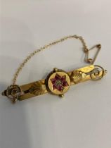 Vintage 9 carat GOLD RUBY and DIAMOND BAR BROOCH. Complete with Gold safety chain. Presented in