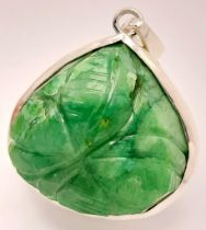 A Carved Trillion Shape 81ct Emerald Pendant set in 925 Silver. 4cm. Comes with a presentation case.