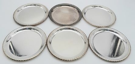 A SET OF SIX SOLID SILVER COASTERS IN 800 SILVER , NICELY EDGED AND BEING 10cms in DIAMETER . 316gms