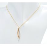 A 9 K yellow gold chain necklace with a modern pendant loaded with round cut diamonds. Chain length: