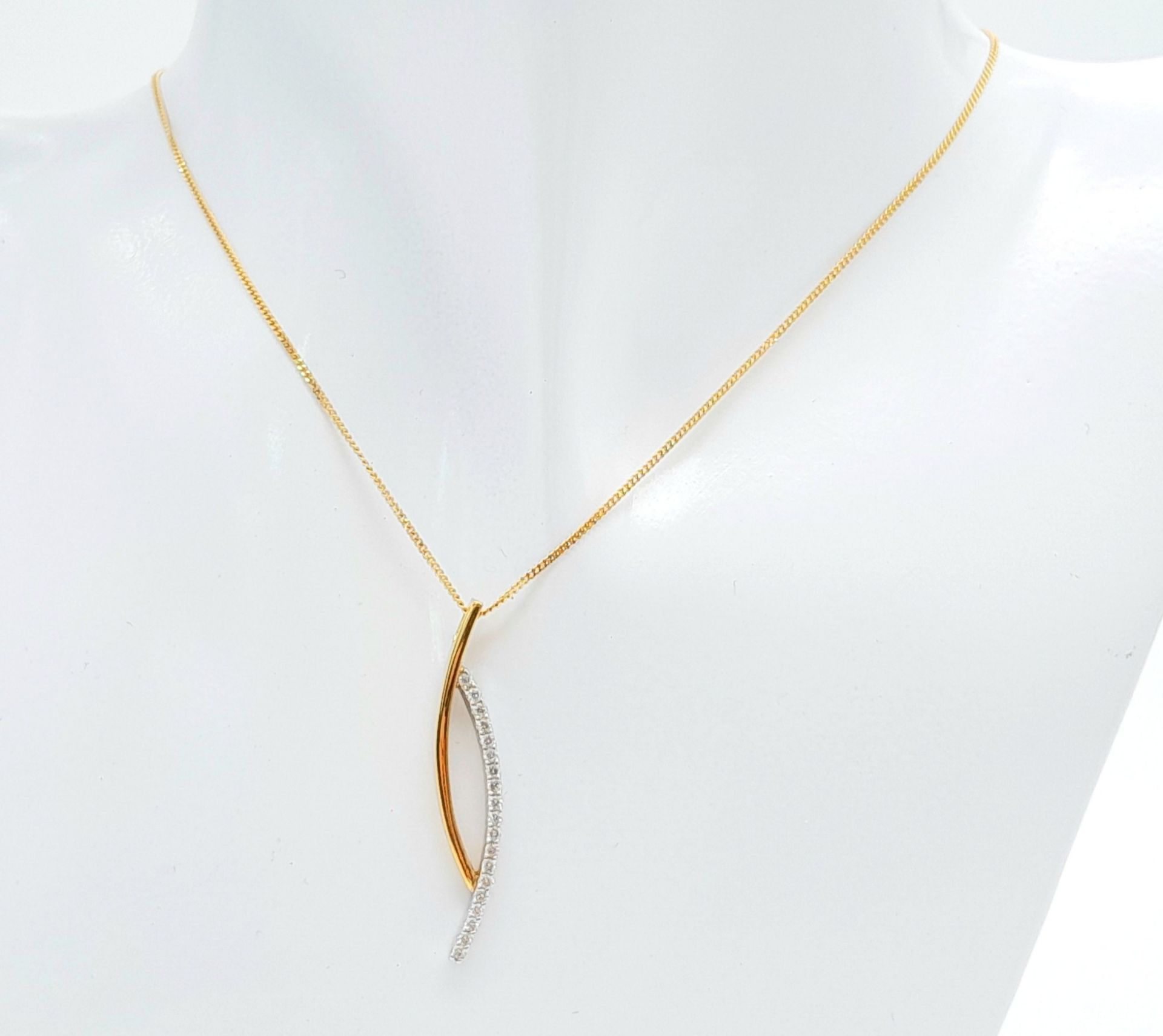 A 9 K yellow gold chain necklace with a modern pendant loaded with round cut diamonds. Chain length: