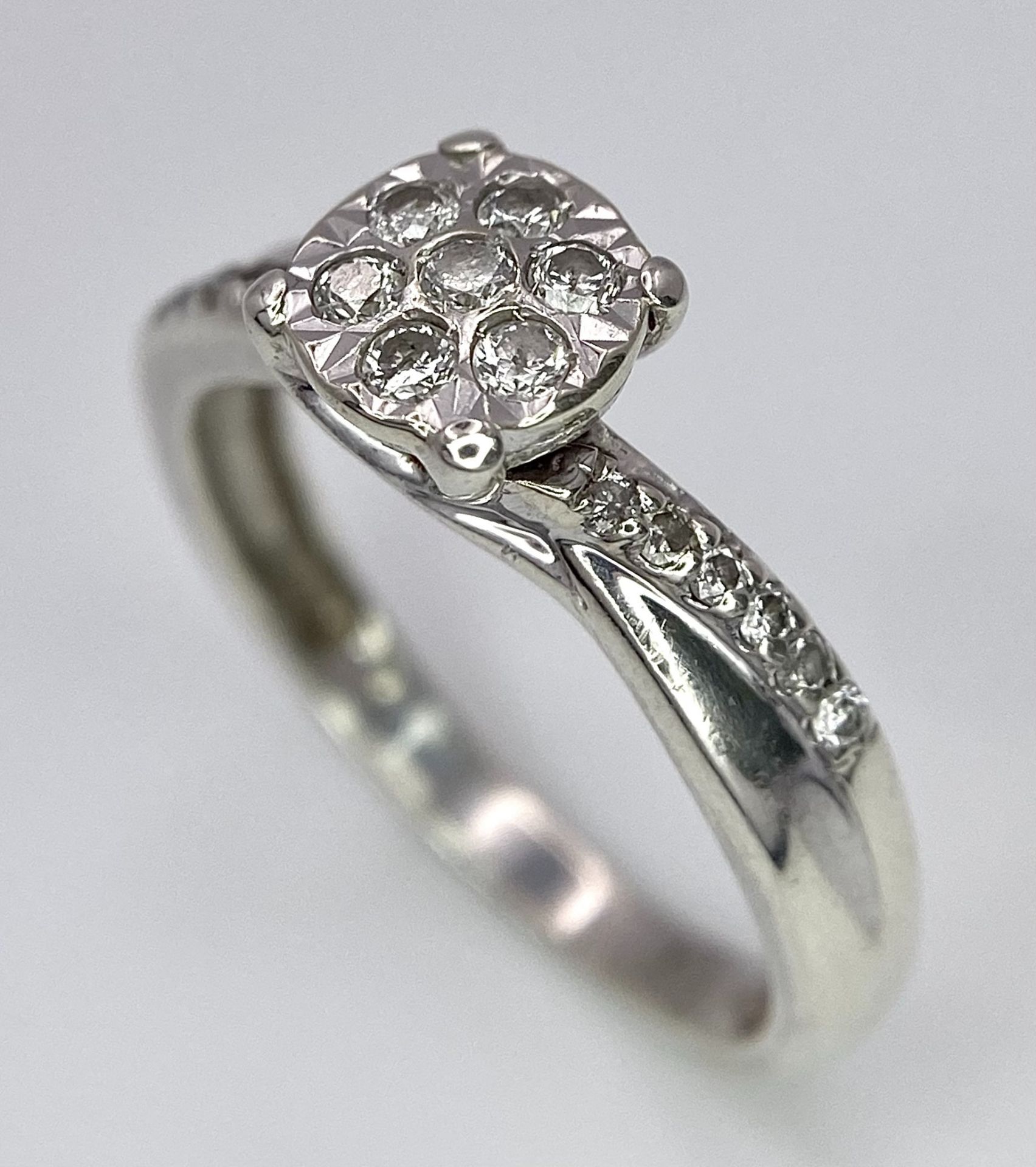 A 9K White Gold Diamond Cluster Ring. Seven small diamonds on a circular base with diamonds on - Image 2 of 6