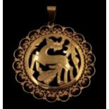 A very elegant, 18 K yellow gold pendant with a deer and vegetation surrounded by refined