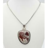 A 925 Silver and Agate Pendant on a 925 Silver Necklace. 35g total weight. 6cm pendant. 42cm